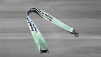 Green lanyard with Proud Feminist - Solidarity in Action in black letters