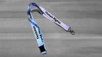 Green lanyard with Feminism Equality Equity Human Rights in black letters