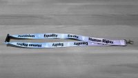 Green lanyard with Feminism Equality Equity Human Rights in black letters