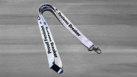 Purple lanyard with Proud Feminist = Change Maker Systems Breaker in black letters